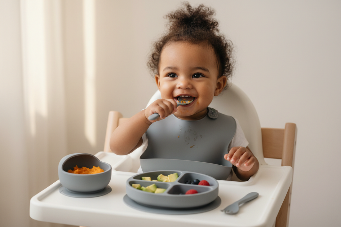 toddler sitting on high baby dining chair , using a grey set of silicon set 