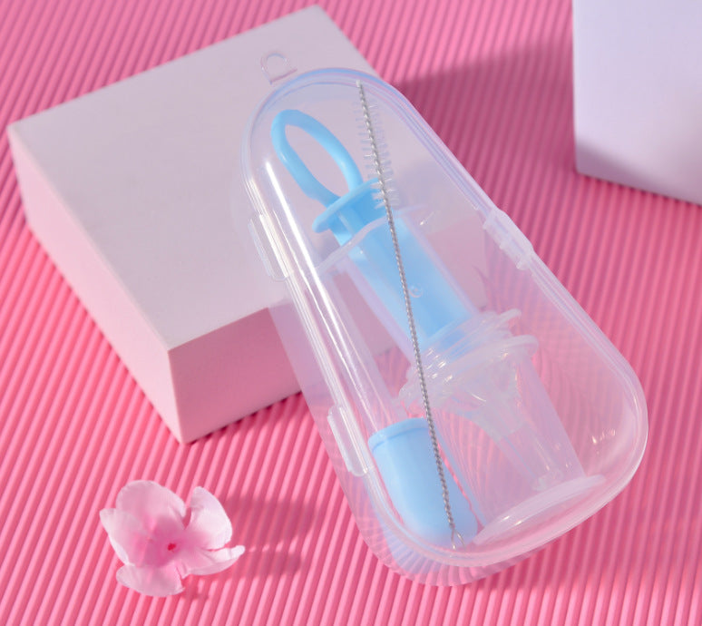 Baby bottle cleaning brush set with blue handle on a pink surface