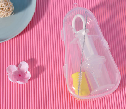 Clear plastic case with a white straw and yellow item on a pink textured surface.