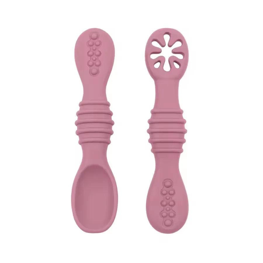 Two pink silicone spoons on a white background