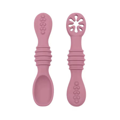 Two pink silicone spoons on a white background