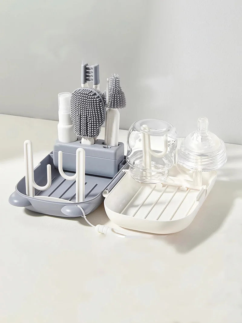 Dish drying rack with various kitchen items on a light surface