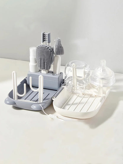 Dish drying rack with various kitchen items on a light surface