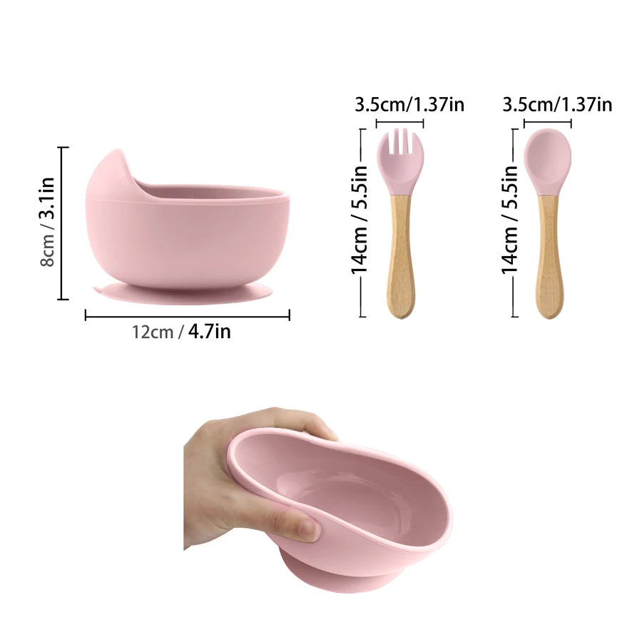 Pink children's bowl, spoon, and fork set with measurements on a white background