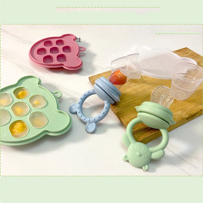 Colorful baby toys including a teething ring, a silicone mold, and a green toy on a light background.