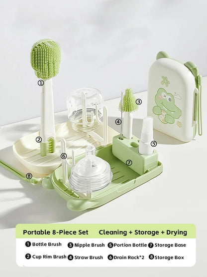 Green and white baby bottle cleaning and drying set with labeled parts on a light gray background.