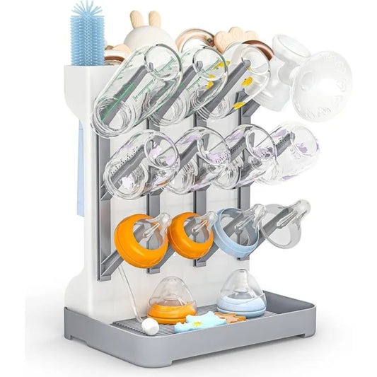Baby bottle drying rack with various baby bottles and accessories on a white background
