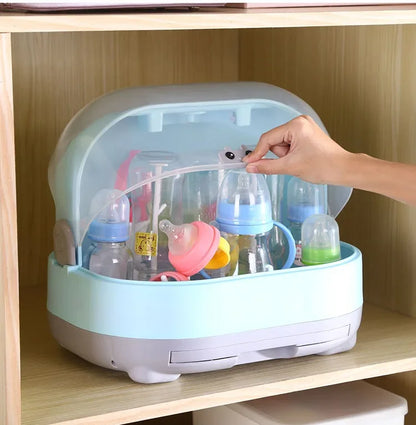 Baby bottle sterilizer with bottles inside on a wooden shelf