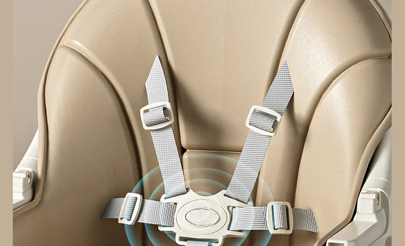Close-up of a beige car seat with gray straps on a neutral background