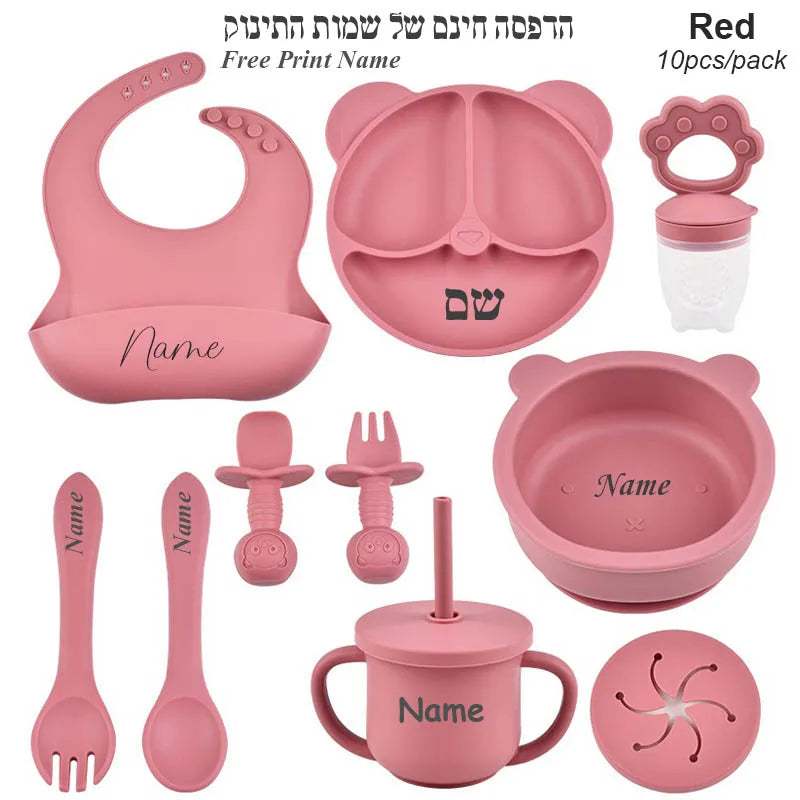Pink baby utensil set with various items on a white background