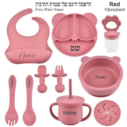 Pink baby utensil set with various items on a white background