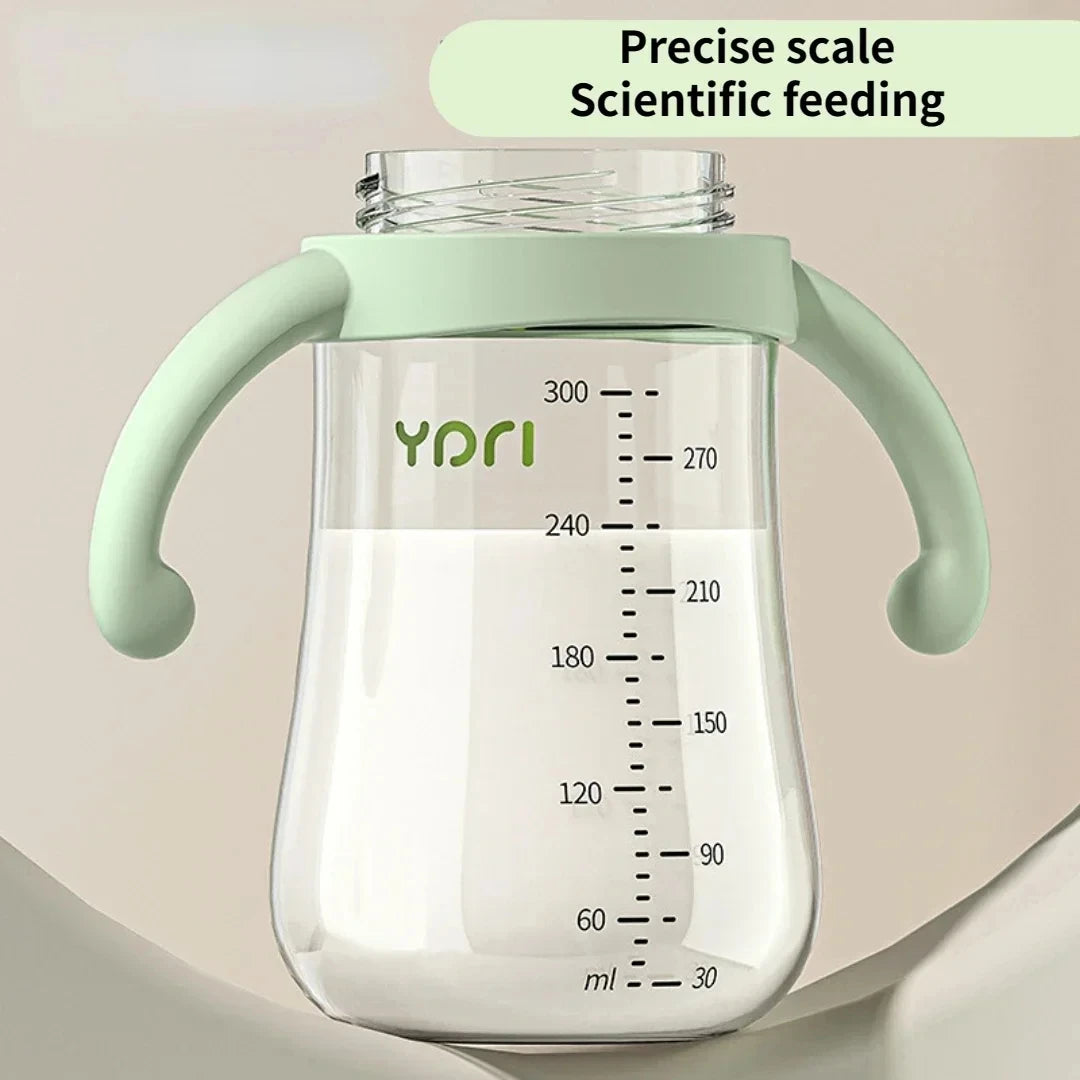 Baby bottle with handles and measurement markings on a beige background