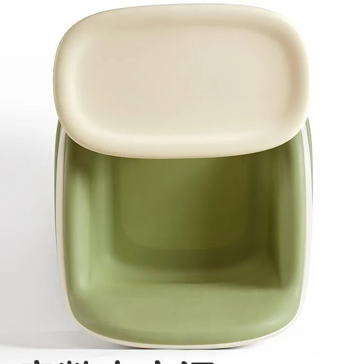 Green and beige square dish on a white background