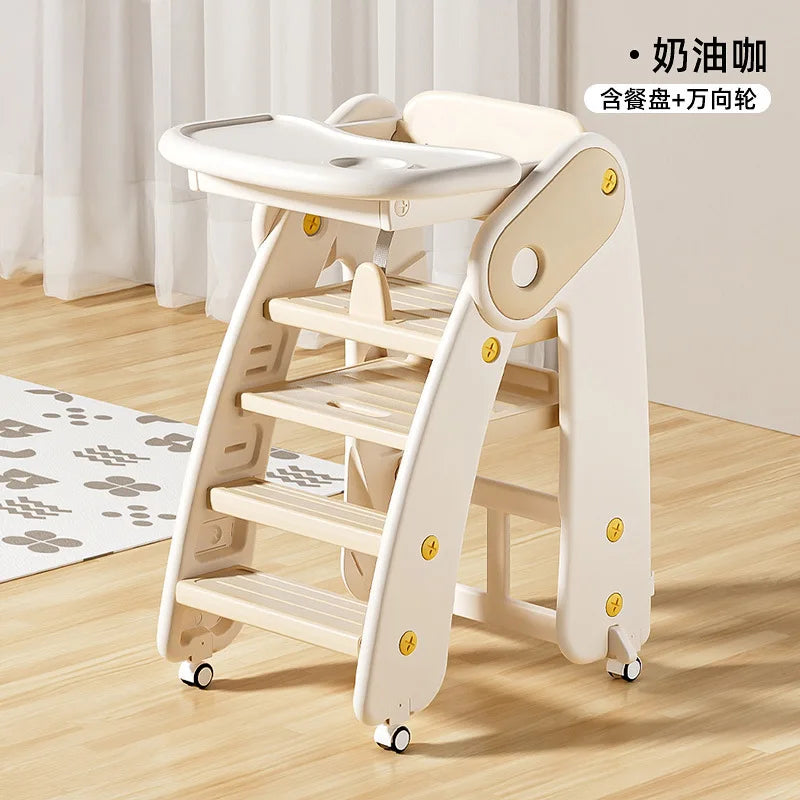 Wooden children's chair with tray on a wooden floor