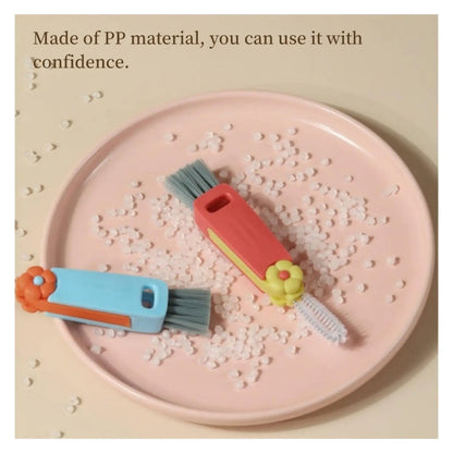 Two small cleaning brushes on a pink plate with text about PP material safety.