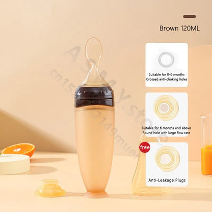 Baby bottle with accessories on a beige background