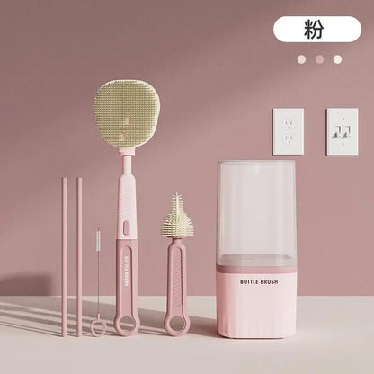 Pink cleaning tools including a swiffer, bottle brush, and dustpan on a pink background.