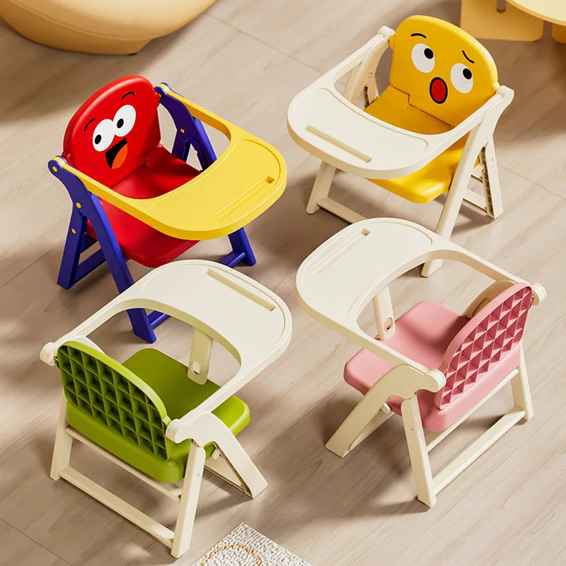 Colorful children's chairs with cartoon face designs on a wooden floor.