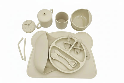 Beige children's dinner set with plate, cups, and cutlery on a white background