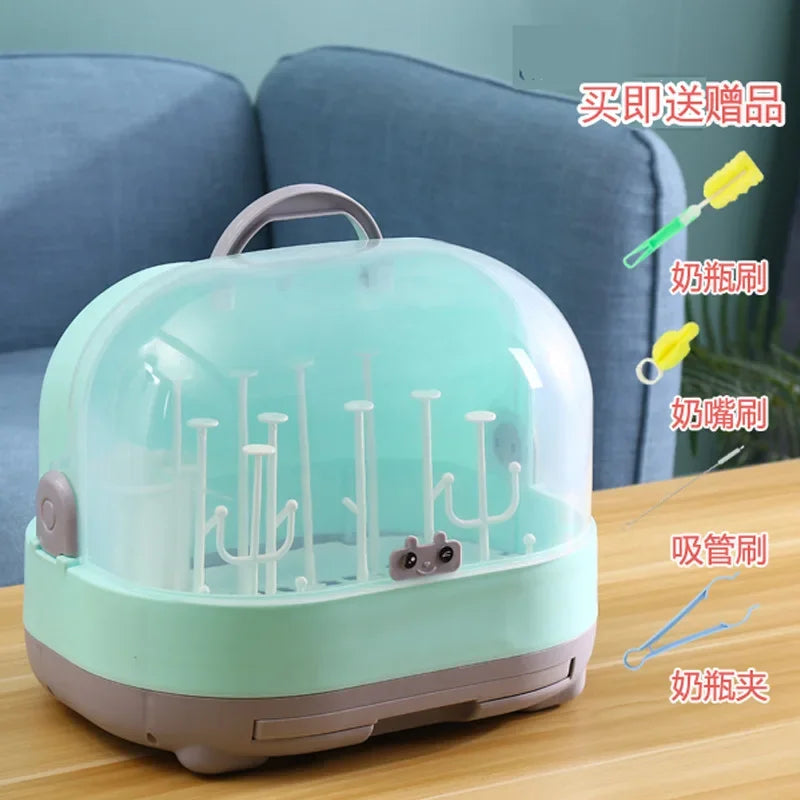 Green baby bottle sterilizer with hooks on a wooden table