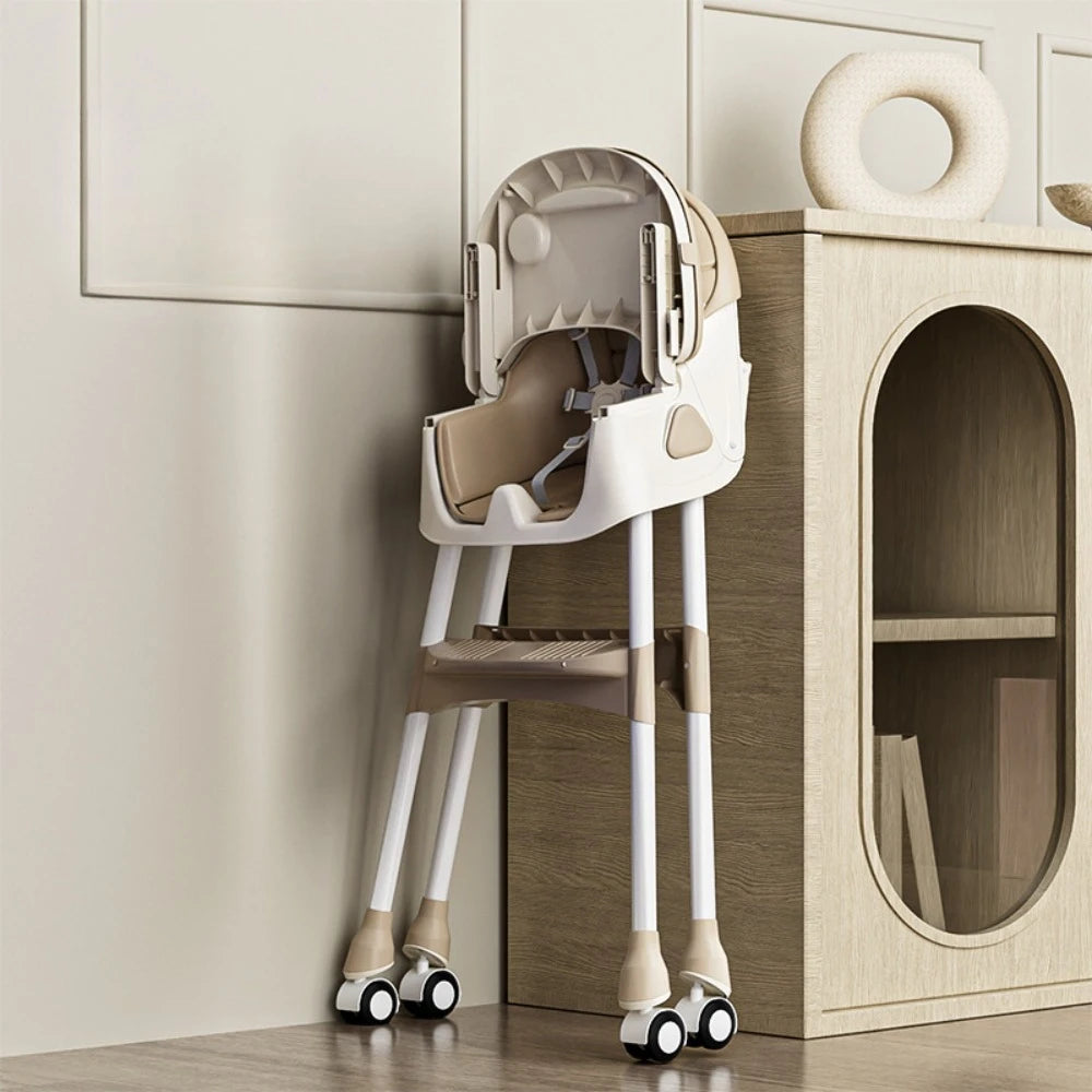 Children's high chair with wheels against a wooden cabinet.