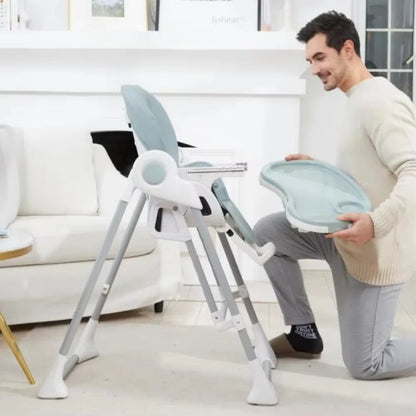 Man setting up a baby high chair in a living room.