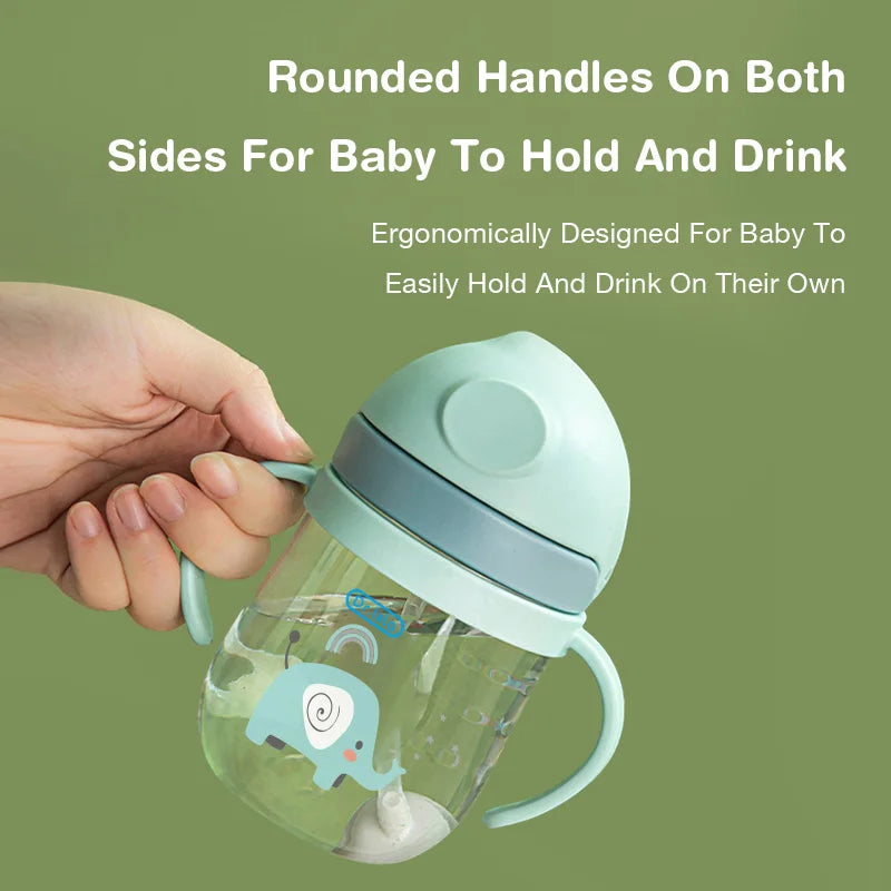 Baby bottle with rounded handles on a green background