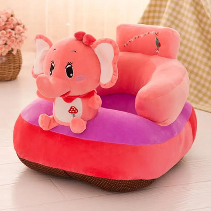 Pink elephant-shaped children's seat on a light wooden floor with a blurred background