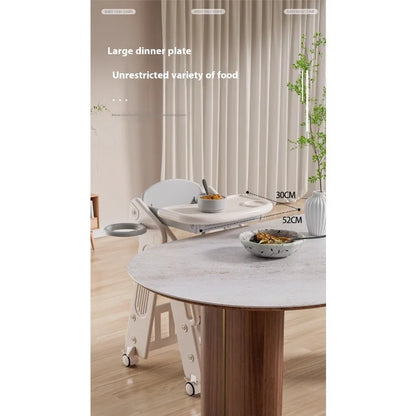 Dining table with a large dinner plate and various food items on a light-colored floor.