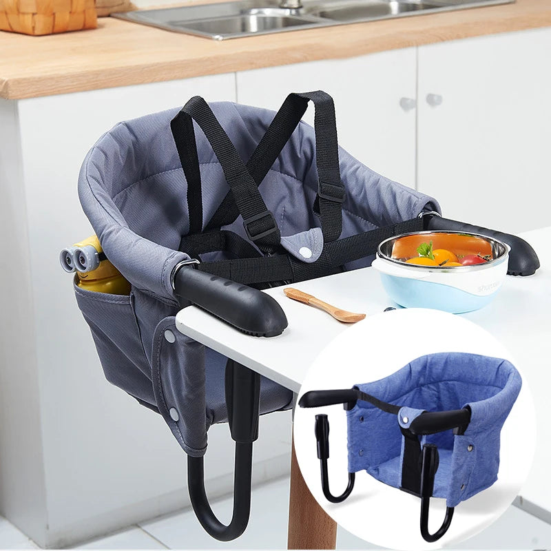 Baby high chair attached to a kitchen table with a bowl of fruit on a white background