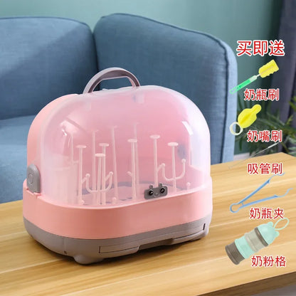 Pink and gray sterilizer with accessories on a wooden table
