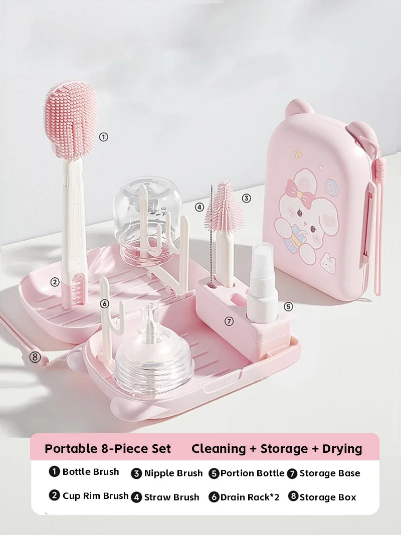 Pink baby bottle cleaning and storage set with various brushes and a case on a white background.