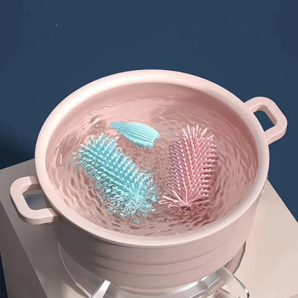 Pink silicone colander with water droplets on a dark blue background