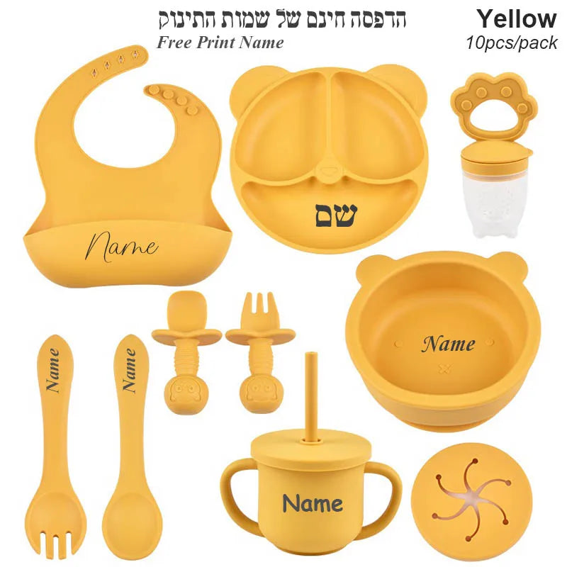 Yellow baby utensil set with various items on a white background