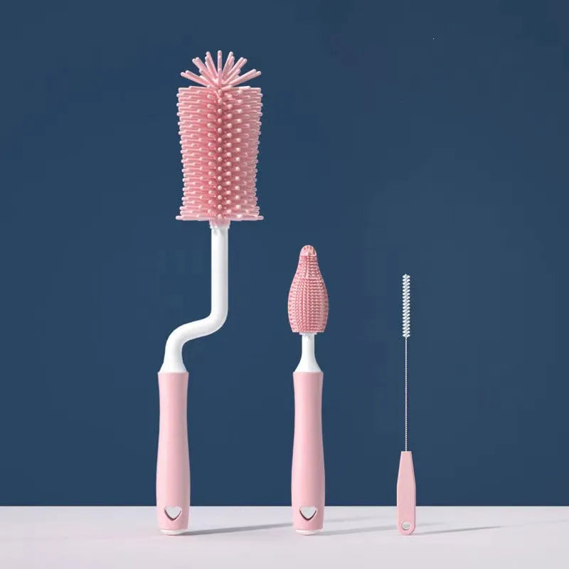 Set of pink bottle cleaning brushes on a blue background