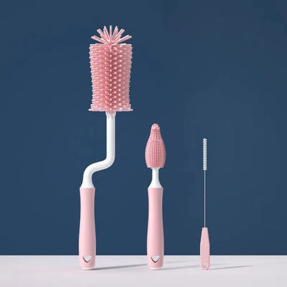 Set of pink bottle cleaning brushes on a blue background