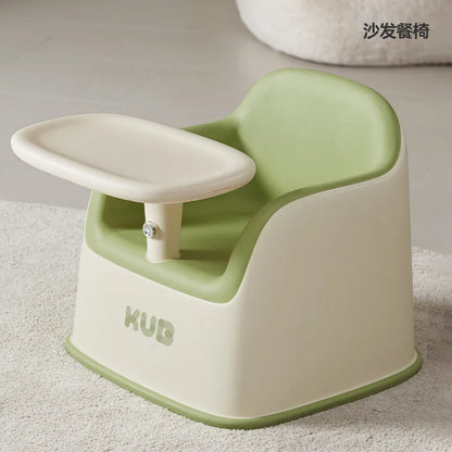 Green and beige baby seat with 'KUB' branding on a light background